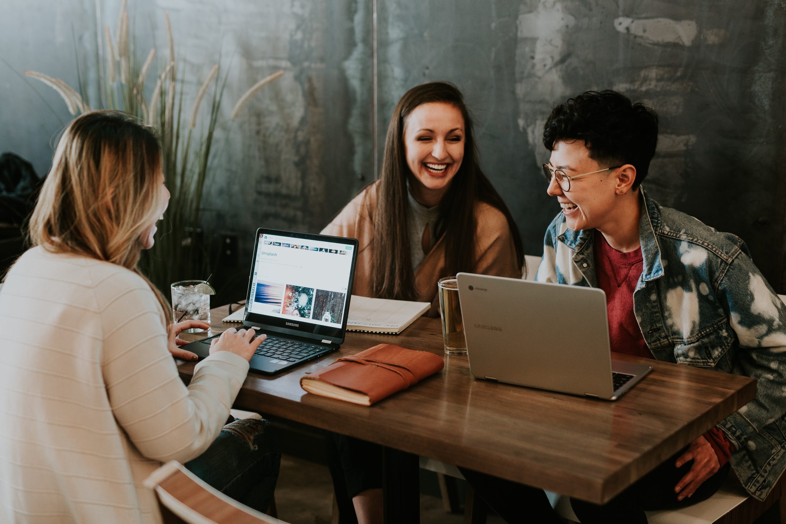 Three people sitting around a table studying and talking